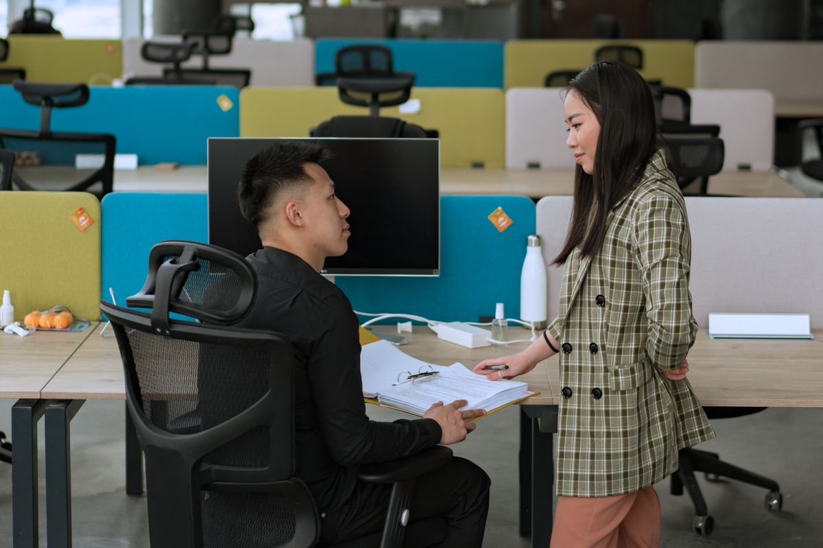 A pair reviewing records on screen